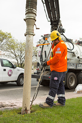 Man operating hydro excavator