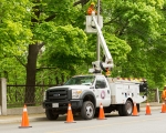 Expand photo of TM3 crew member working on street light