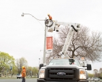Expand photo of TM3 crew installing LED fixtures on street light